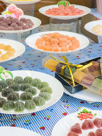 Colorful Candied Fruit Jellies Displayed on Plates, creating a Vibrant and Delicious Arrangementの写真素材