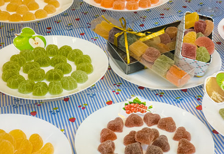 Colorful Candied Fruit Jellies Displayed on Plates, creating a Vibrant and Delicious Arrangementの写真素材