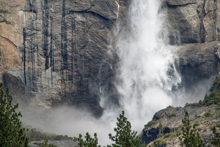 Yosemite Lower Fall crashing onto granite cliff creating mistの写真素材