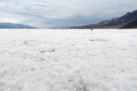 Badwater Basin salt flats in Death Valley National Park under cloudy skyの写真素材