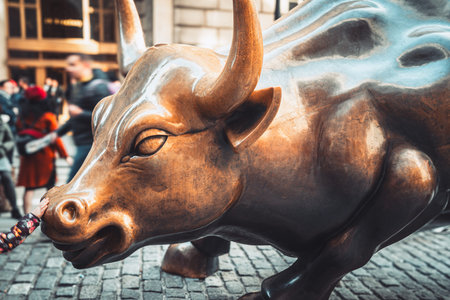 Wall Street charging bull statue in New York City with peopleの写真素材
