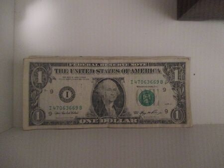 Dollar bills in a white drawer