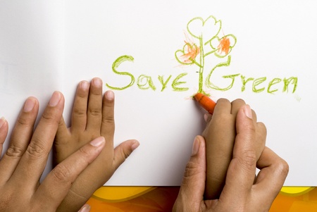 Mother helping her son for write the save green word 