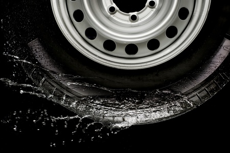 Car tire splashing in water, Tire with water 