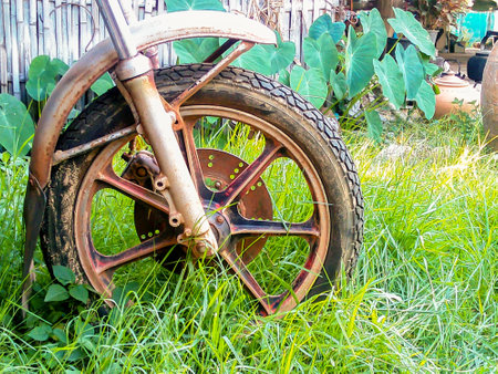 Wheel motorbike old handmade. The image is not being left in the wilderness looked a classic art form.の写真素材