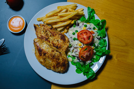 Grilled steak and lettuce, French fries on wooden plateの写真素材