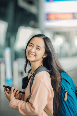 Young beautiful female traveler at the airport traveling.の写真素材
