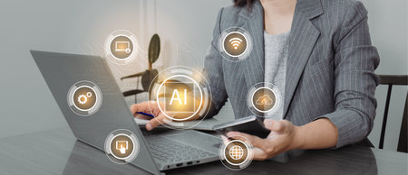 Businesswoman using smart phone and laptop with artificial intelligence (AI) concept.の写真素材