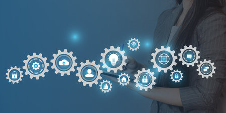 Businesswoman using tablet computer with cloud computing icons on blue background.の写真素材