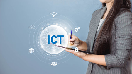 Businesswoman holding tablet with ICT technology concept on the blue backgroundの写真素材