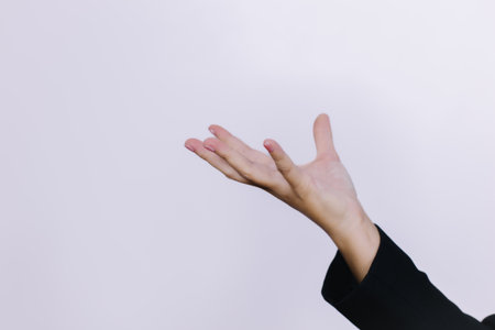 Close-up of businesswoman's hand showing something on white backgroundの写真素材