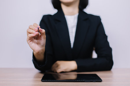 Businesswoman working on tablet computer in office. Business and technology concept.の写真素材
