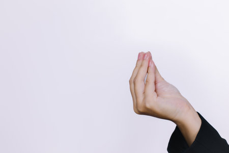 Businesswoman making a gesture with her fingers on a white background.の写真素材