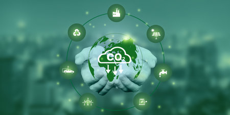 Hand holding Co2 icon on virtual screen Reduce CO2 emissions to limit global warming. Lower CO2...