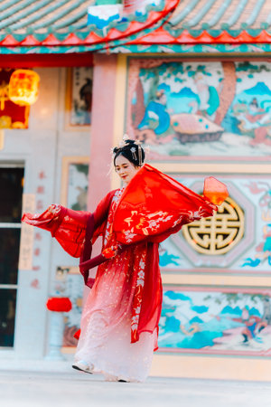 Woman dress China New year. portrait of a woman. person in traditional costume. woman in traditional costume. Beautiful young woman in a bright red dress and a crown of Chinese Queen posing.の写真素材