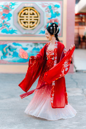 Woman dress China New year. portrait of a woman. person in traditional costume. woman in traditional costume. Beautiful young woman in a bright red dress and a crown of Chinese Queen posing.の写真素材