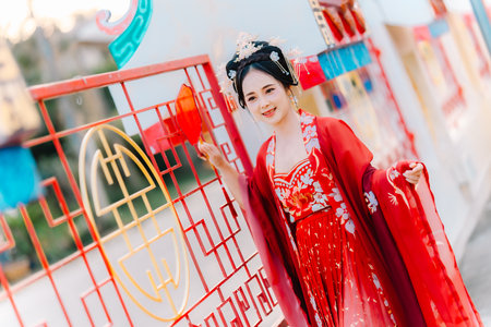 Woman dress China New year. portrait of a woman. person in traditional costume. woman in traditional costume. Beautiful young woman in a bright red dress and a crown of Chinese Queen posing.の写真素材