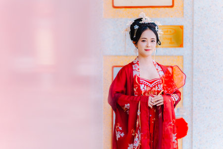 Woman dress China New year. portrait of a woman. person in traditional costume. woman in traditional costume. Beautiful young woman in a bright red dress and a crown of Chinese Queen posing.の写真素材