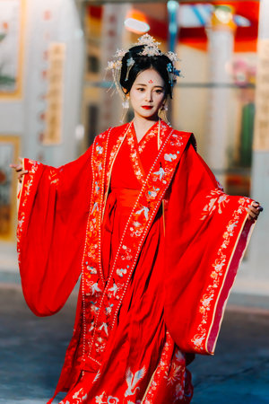 Woman dress China New year. portrait of a woman. person in traditional costume. woman in traditional costume. Beautiful young woman in a bright red dress and a crown of Chinese Queen posing.の写真素材