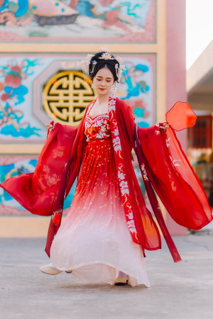 Woman dress China New year. portrait of a woman. person in traditional costume. woman in traditional costume. Beautiful young woman in a bright red dress and a crown of Chinese Queen posing.の写真素材