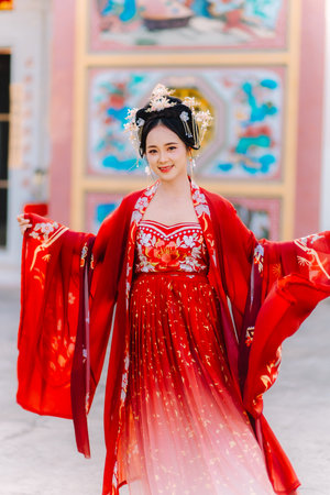 Woman dress China New year. portrait of a woman. person in traditional costume. woman in traditional costume. Beautiful young woman in a bright red dress and a crown of Chinese Queen posing.の写真素材