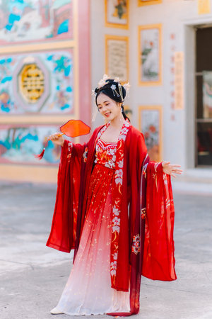Woman dress China New year. portrait of a woman. person in traditional costume. woman in traditional costume. Beautiful young woman in a bright red dress and a crown of Chinese Queen posing.の写真素材