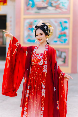 Woman dress China New year. portrait of a woman. person in traditional costume. woman in traditional costume. Beautiful young woman in a bright red dress and a crown of Chinese Queen posing.の写真素材