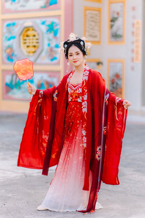 Woman dress China New year. portrait of a woman. person in traditional costume. woman in traditional costume. Beautiful young woman in a bright red dress and a crown of Chinese Queen posing.の写真素材