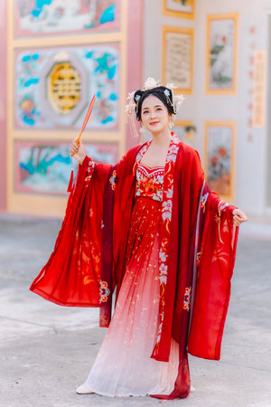 Woman dress China New year. portrait of a woman. person in traditional costume. woman in traditional costume. Beautiful young woman in a bright red dress and a crown of Chinese Queen posing.の写真素材