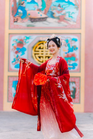 Woman dress China New year. portrait of a woman. person in traditional costume. woman in traditional costume. Beautiful young woman in a bright red dress and a crown of Chinese Queen posing.の写真素材