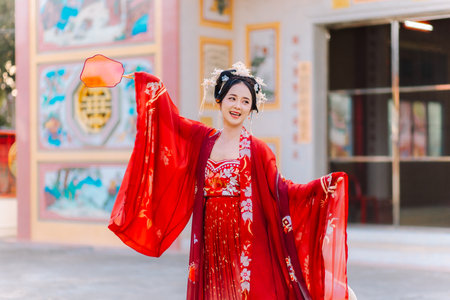 Woman dress China New year. portrait of a woman. person in traditional costume. woman in traditional costume. Beautiful young woman in a bright red dress and a crown of Chinese Queen posing.の写真素材