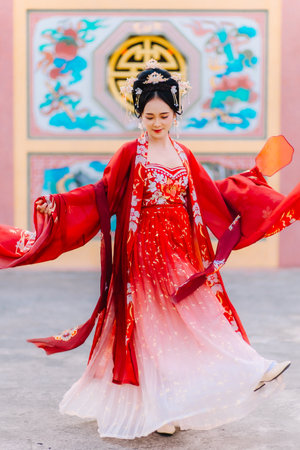 Woman dress China New year. portrait of a woman. person in traditional costume. woman in traditional costume. Beautiful young woman in a bright red dress and a crown of Chinese Queen posing.の写真素材