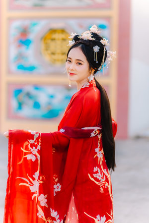 Woman dress China New year. portrait of a woman. person in traditional costume. woman in traditional costume. Beautiful young woman in a bright red dress and a crown of Chinese Queen posing.の写真素材