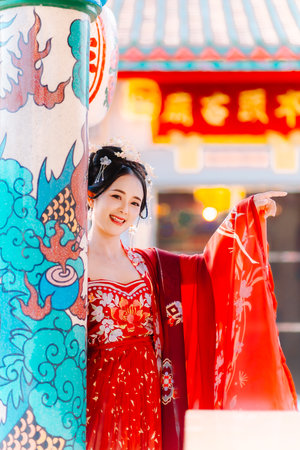 Woman dress China New year. portrait of a woman. person in traditional costume. woman in traditional costume. Beautiful young woman in a bright red dress and a crown of Chinese Queen posing.の写真素材