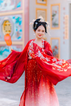 Woman dress China New year. portrait of a woman. person in traditional costume. woman in traditional costume. Beautiful young woman in a bright red dress and a crown of Chinese Queen posing.の写真素材