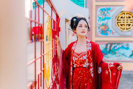 Woman dress China New year. portrait of a woman. person in traditional costume. woman in traditional costume. Beautiful young woman in a bright red dress and a crown of Chinese Queen posing.の写真素材