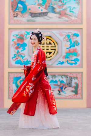 Woman dress China New year. portrait of a woman. person in traditional costume. woman in traditional costume. Beautiful young woman in a bright red dress and a crown of Chinese Queen posing.の写真素材