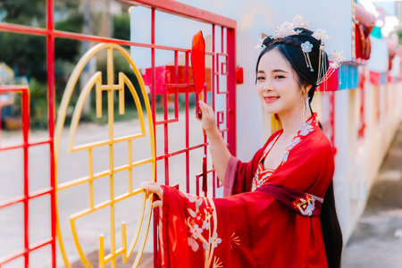 Woman dress China New year. portrait of a woman. person in traditional costume. woman in traditional costume. Beautiful young woman in a bright red dress and a crown of Chinese Queen posing.の写真素材