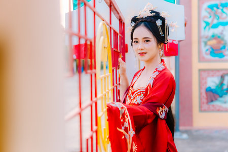 Woman dress China New year. portrait of a woman. person in traditional costume. woman in traditional costume. Beautiful young woman in a bright red dress and a crown of Chinese Queen posing.の写真素材
