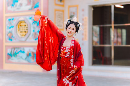 Woman dress China New year. portrait of a woman. person in traditional costume. woman in traditional costume. Beautiful young woman in a bright red dress and a crown of Chinese Queen posing.の写真素材