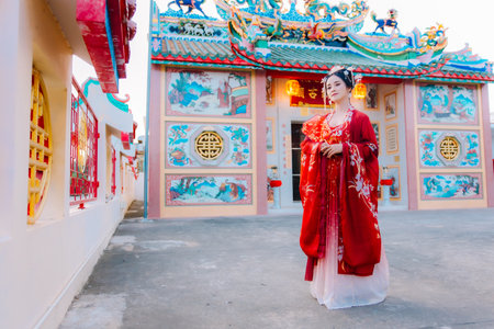 Woman dress China New year. portrait of a woman. person in traditional costume. woman in traditional costume. Beautiful young woman in a bright red dress and a crown of Chinese Queen posing.の写真素材