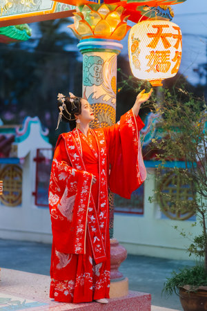 Woman dress China New year. portrait of a woman. person in traditional costume. woman in traditional costume. Beautiful young woman in a bright red dress and a crown of Chinese Queen posing.の写真素材