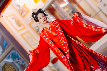 Woman dress China New year. portrait of a woman. person in traditional costume. woman in traditional costume. Beautiful young woman in a bright red dress and a crown of Chinese Queen posing.の写真素材
