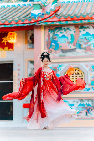 Woman dress China New year. portrait of a woman. person in traditional costume. woman in traditional costume. Beautiful young woman in a bright red dress and a crown of Chinese Queen posing.の写真素材