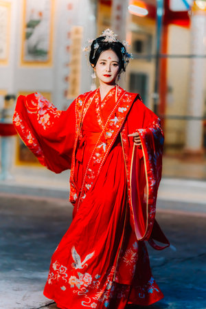Woman dress China New year. portrait of a woman. person in traditional costume. woman in traditional costume. Beautiful young woman in a bright red dress and a crown of Chinese Queen posing.の写真素材