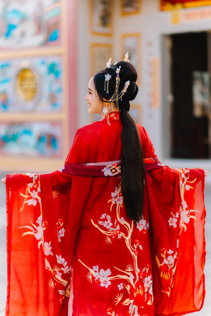Woman dress China New year. portrait of a woman. person in traditional costume. woman in traditional costume. Beautiful young woman in a bright red dress and a crown of Chinese Queen posing.の写真素材