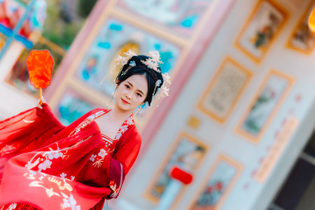 Woman dress China New year. portrait of a woman. person in traditional costume. woman in traditional costume. Beautiful young woman in a bright red dress and a crown of Chinese Queen posing.の写真素材