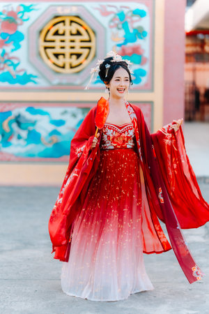 Woman dress China New year. portrait of a woman. person in traditional costume. woman in traditional costume. Beautiful young woman in a bright red dress and a crown of Chinese Queen posing.の写真素材