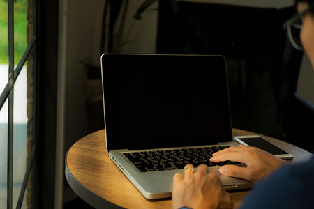 Close up hands man using laptop の写真素材
