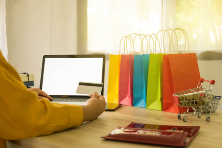 Woman holding credit card and using laptop for shopping online.の写真素材